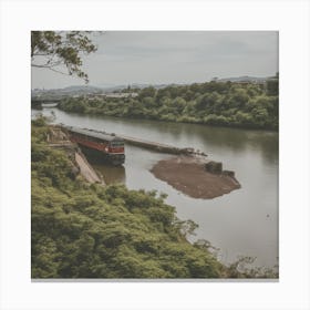 A Train Passes In Front Of The River With Green Trees Canvas Print