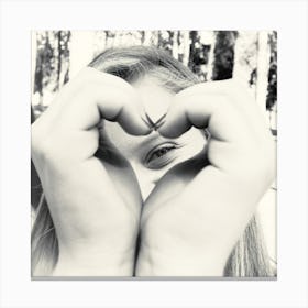 Woman Peeking Through A Heart Shape She Does With Her Hands Canvas Print
