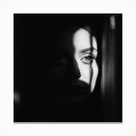 A Face Partially Illuminated Half Shrouded In Shadows Appears Through The Interplay Of Stark Light Canvas Print