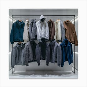 A rack of men's jackets and hoodies on a rack 1 Canvas Print