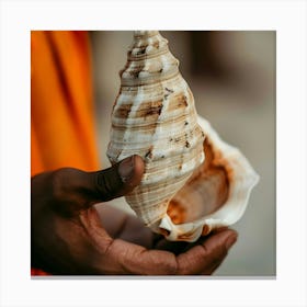 Man Holding A Seashell Canvas Print