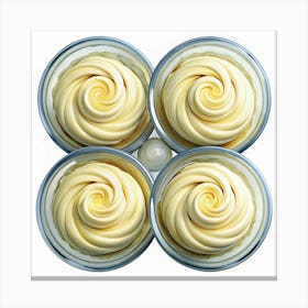 Four Swirls Of Yellow Cream In Glass Containers Canvas Print