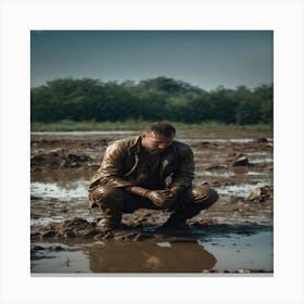 Man Kneeling In Mud Canvas Print