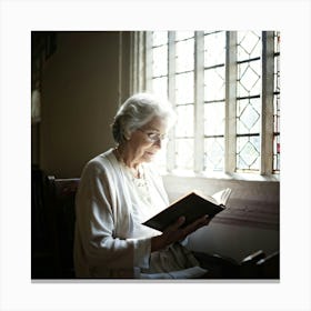 An Elderly Woman Of Faith Dressed In A White Cardigan Is Absorbed In Reading The Holy Bible Her H (6) Canvas Print