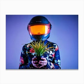 Portrait In A Futuristic Helmet Cradling A Luminescent Plant Bright Orange Against A Shadowed Back Canvas Print