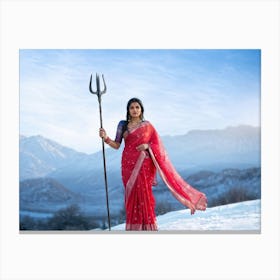 Indian Woman Clad In Traditional Silk Sari Clasps A Trident As She Strides Towards Towering Snowy Canvas Print