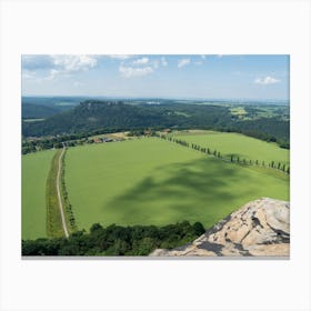 View of a green field from the summit of the Lilienstein Canvas Print