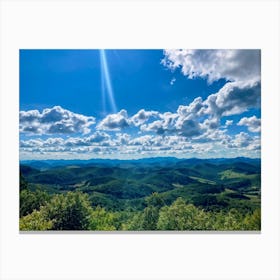 Cumulus Clouds Strewn Across A Blue Sky Above A Sweeping Scenic Landscape Vibrant Greenery Rollin (2) Canvas Print