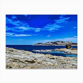 Rocky Coastal Landscape in Sardinia. A serene coastal landscape. The foreground features a rocky shoreline, with the ocean stretching out in the distance. A small, weathered stone tower stands on a rocky outcropping, adding a sense of history and mystery to the scene. The sky is filled with soft, fluffy clouds, creating a peaceful and contemplative atmosphere. Canvas Print