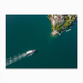 The boat sails to the island on the lake in Italy. Drone photography Canvas Print