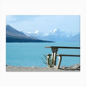 Azure lake and bench  in front of mountains New Zealand  Canvas Print