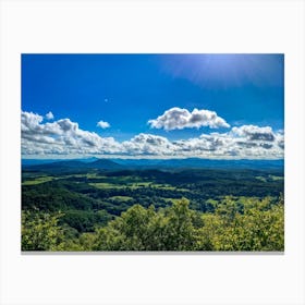 Cumulus Clouds Strewn Across A Blue Sky Above A Sweeping Scenic Landscape Vibrant Greenery Rollin (4) Canvas Print