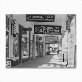 Signs On Main Street Of Saint Martinville, Louisana, Under Overhanging Balcony, These Overhanging Balconies Are A Canvas Print