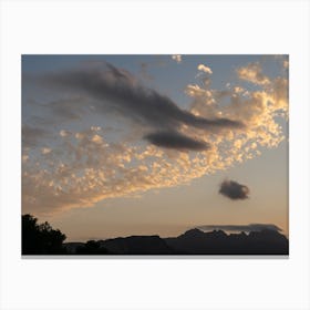 Cloudy sky and mountain silhouette at sunset Canvas Print
