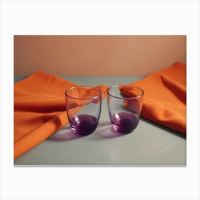 Two Purple Rimmed Glasses Sit On A Gray Surface With Orange Fabric Draped Around Them, Creating A Simple And Elegant Still Life Canvas Print