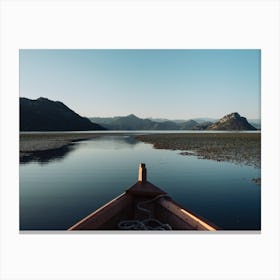 Boat on a lake reflection Canvas Print
