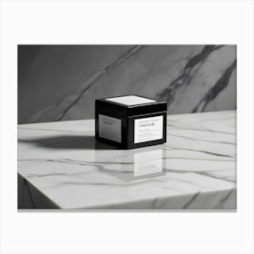 A Black, Square Box With The Word Valoisa Printed On It, Placed On A White Marble Surface Canvas Print