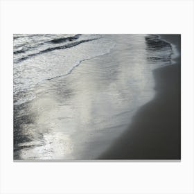 Silver reflections in wet sand on the beach Canvas Print