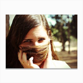 Woman Hiding Her Face With Her Hair Looking At Camera Canvas Print