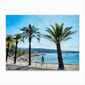 Palm Trees Beach Scene in French Riviera. A picturesque beach scene unfolds with a row of palm trees framing the view. The azure sky stretches above, while the clear blue water laps at the shore. A man in blue shorts jogs along the boardwalk, passing by a lively crowd of people enjoying the sun and sand. Colorful umbrellas dot the beach, adding a splash of vibrancy to the scene. Canvas Print