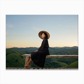 Evening View Of An Asian Woman Perched Solo On A Wooden Terrace Decked In A Summer Hat Her Black At Canvas Print