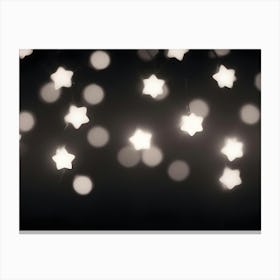 A Photograph Of A String Of White Star Shaped Lights On A Dark Background Canvas Print