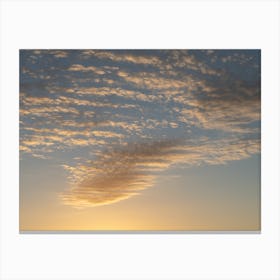 Golden-yellow clouds in the sky at sunrise Canvas Print