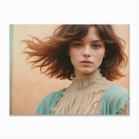 A Portrait Of A Young Woman With Windswept Hair, Looking Directly At The Camera Canvas Print