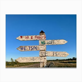 A Weathered Wooden Signpost At A Crossroad Its Arrows Pointing In Various Directions With Hand Pain (1) Canvas Print