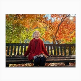 Elderly Woman Radiating Joy Seated On A Rustic Wooden Bench In A Lush Park Surrounded By A Kaleido (1) 2 Canvas Print