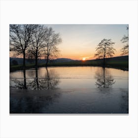 Winter reflection of trees in a pond at sunset Canvas Print