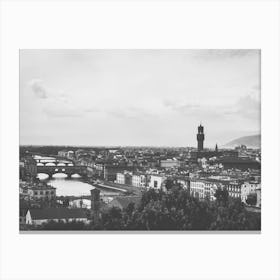 Panoramic View of Florence. This image depicts a panoramic view of Florence, Italy, showcasing its iconic architectural landmarks. The prominent structures include the Florence Cathedral with its distinctive dome and the Palazzo Vecchio with its tall tower. The cityscape is set against a backdrop of rolling hills and a partly cloudy sky, capturing the historical and cultural essence of Florence. Canvas Print