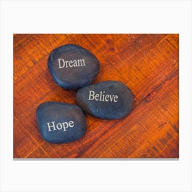 Black Inspirational Pebble Stones With The Words Dream, Believe And Hope On Wooden Background 1 Canvas Print