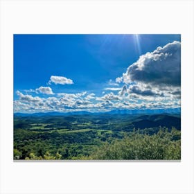 Cumulus Clouds Strewn Across A Blue Sky Above A Sweeping Scenic Landscape Vibrant Greenery Rollin (6) Canvas Print