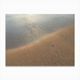 Beige sand and sea water at sunrise Canvas Print
