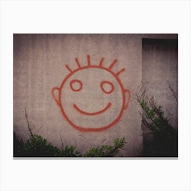 Graffiti Painting Of Red Happy Smiley Face On A Concrete Wall Canvas Print
