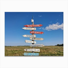 A Weathered Wooden Signpost At A Crossroad Its Arrows Pointing In Various Directions With Hand Pain Canvas Print