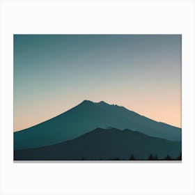 Photo Of A Mountain Range Silhouetted Against A Blue And Orange Sky Canvas Print