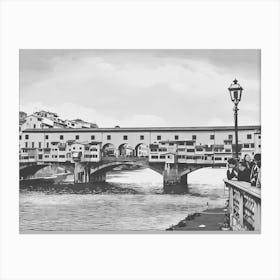 Ponte Vecchio Over the Arno River. A black-and-white depiction of Florence’s iconic Ponte Vecchio bridge, stretching over the Arno River. This historic bridge, adorned with small shops and classic Italian architecture, embodies the timeless beauty of Florence. Canvas Print