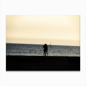 Silhouette Of An Embracing Couple Looking At The Sea Canvas Print
