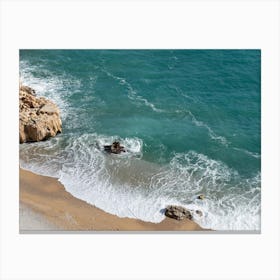 Aerial view of waves and foaming sea water on the beach Canvas Print