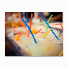 Selection Of Plastic Cups With Grapefruit Juice And Colored Straws Canvas Print