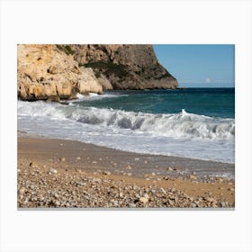 Waves and cliffs on the beach Canvas Print