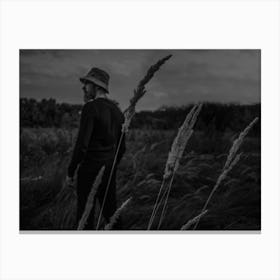 A Man In A Field With Spikelets Against The Background Of The Forest Canvas Print