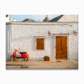 Red Vespa parked in front of a trulli | Puglia | Italy Canvas Print