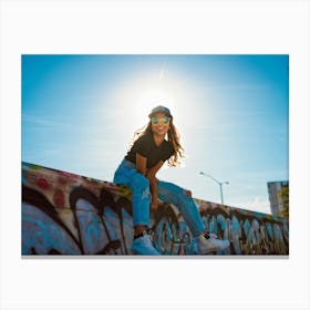 Stylish Girl Wearing A Cap Yellow Sunglasses Perched On The Edge Of Her Nose Leaning Against A Gra Canvas Print