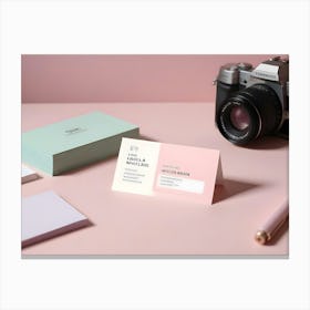 Photo Of A Business Card With A Camera, A Pen, And A Stack Of Business Cards On A Pink Surface Canvas Print