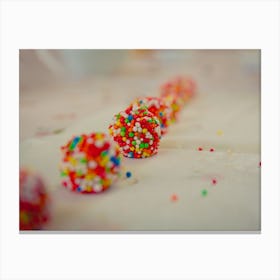Close Up On White Chocolate Balls Covered With Candies Arranged In A Row Canvas Print