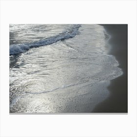 Sea water and silver reflections in wet sand Canvas Print