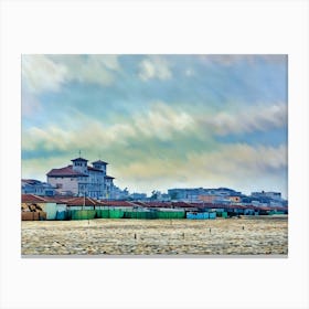 Coastal Serenity in Viareggio. A tranquil view of Viareggio's beach area, featuring iconic seaside structures and vibrant beach cabins, under a dramatic sky. The soft pastel tones of the scene reflect the relaxed charm of Versilia's coastline. Canvas Print